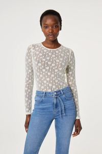Model wearing a patterned long-sleeve cream lacey Fabienne Chapot top 