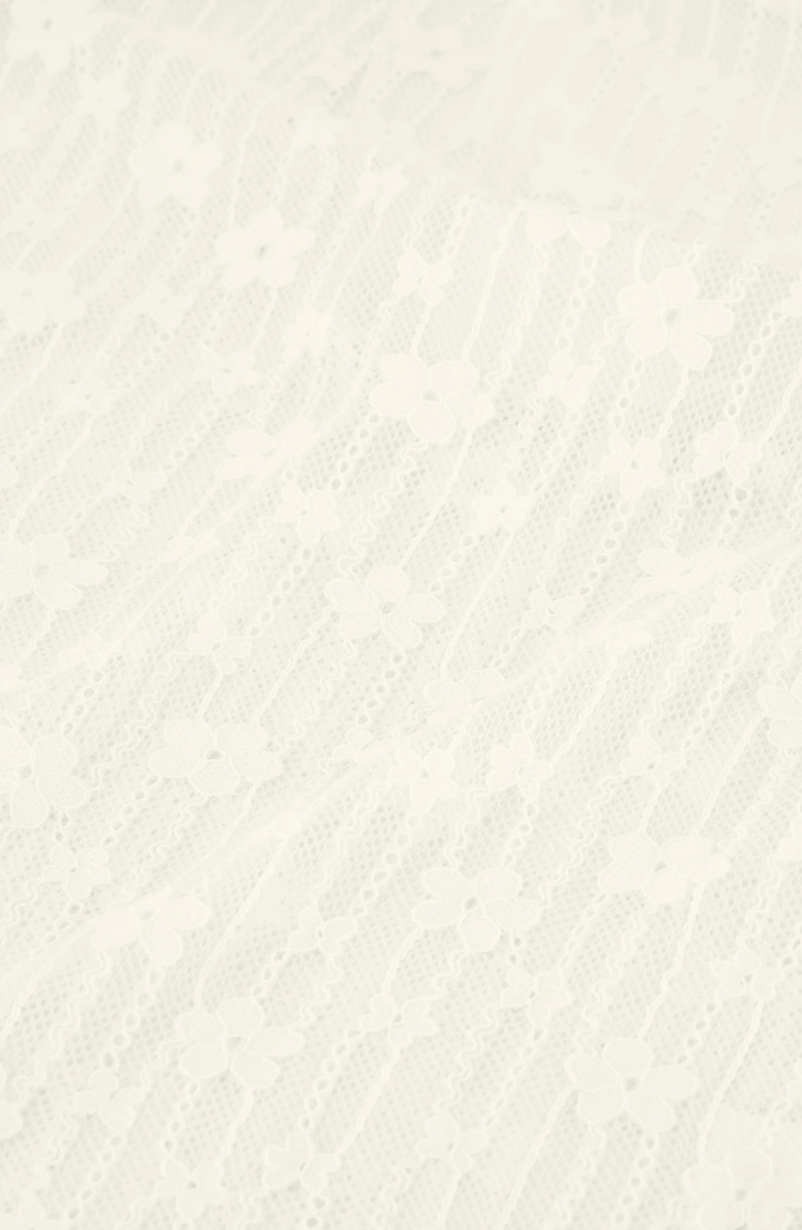 close up detail of patterned long-sleeve cream lacey Fabienne Chapot top