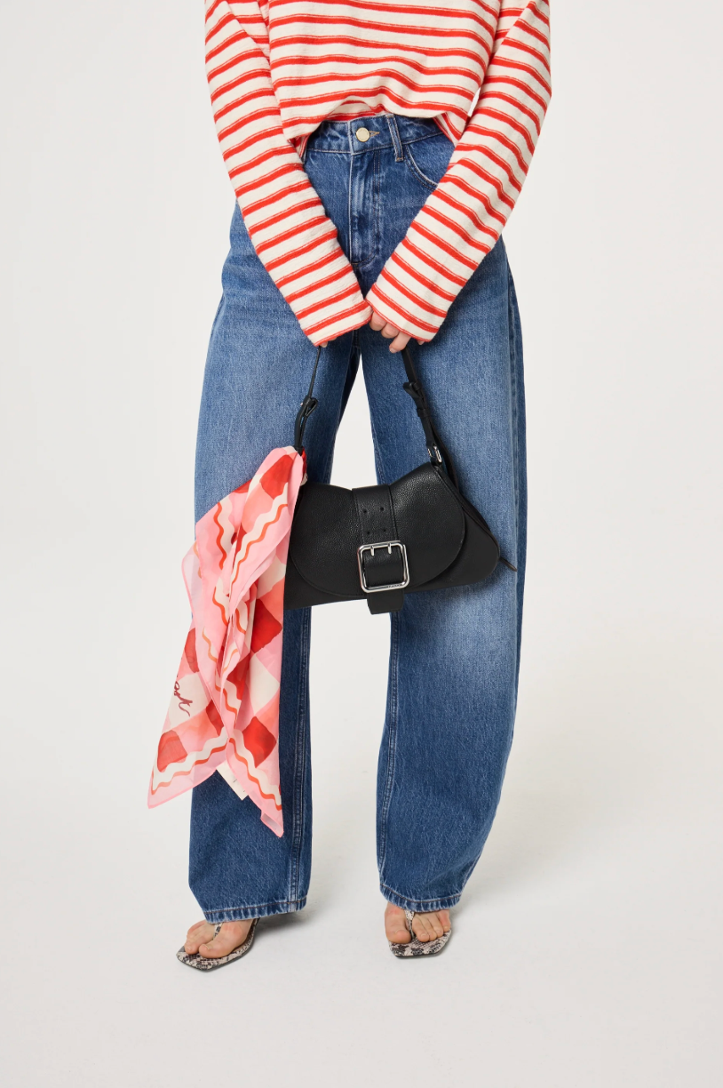 Model has the Lovely Lobster scarf by Fabienne Chapot tied around the handle of a bag