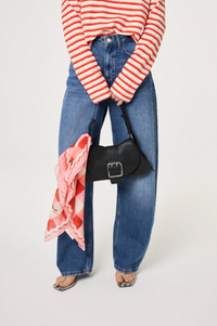 Model has the Lovely Lobster scarf by Fabienne Chapot tied around the handle of a bag