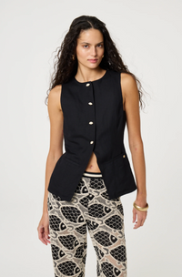 models wears a black round necked Fabienne Chapot waistcoat with small cream buttons