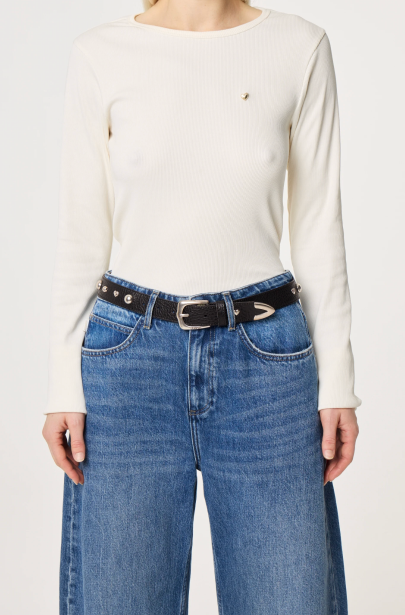 Black  belt by Fabienne Chapot with silver ball and heart studs and buckle worn by model on jeans