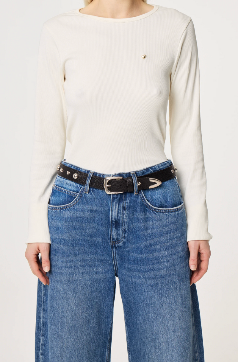 Black  belt by Fabienne Chapot with silver ball and heart studs and buckle worn by model on jeans