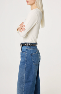 Black  belt by Fabienne Chapot with silver ball and heart studs and buckle worn on model, side view
