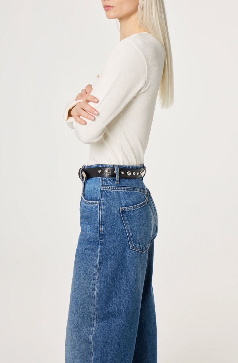 Black  belt by Fabienne Chapot with silver ball and heart studs and buckle worn on model, side view