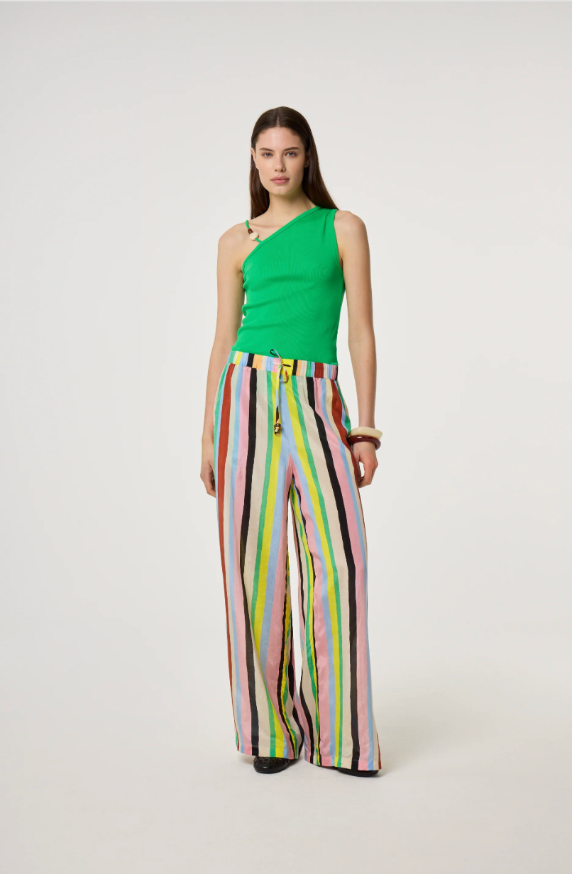 Model is wearing a green top and colorful Fabienne Chapot striped pants 