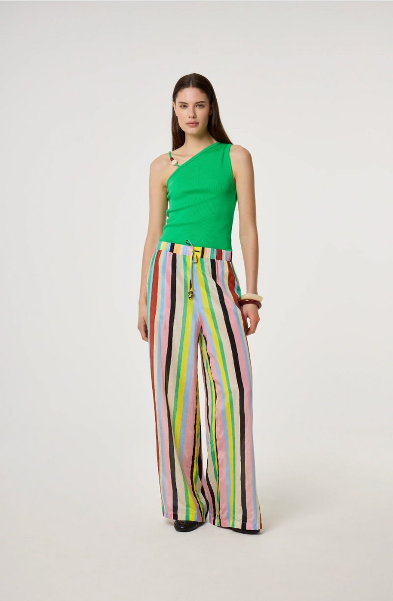Model is wearing a green top and colorful Fabienne Chapot striped pants 