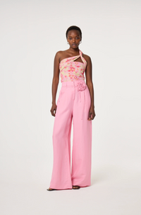 Model wearing a floral one-shoulder top and pink linen mix Fabienne Chapot wide-leg pants with corsage belt