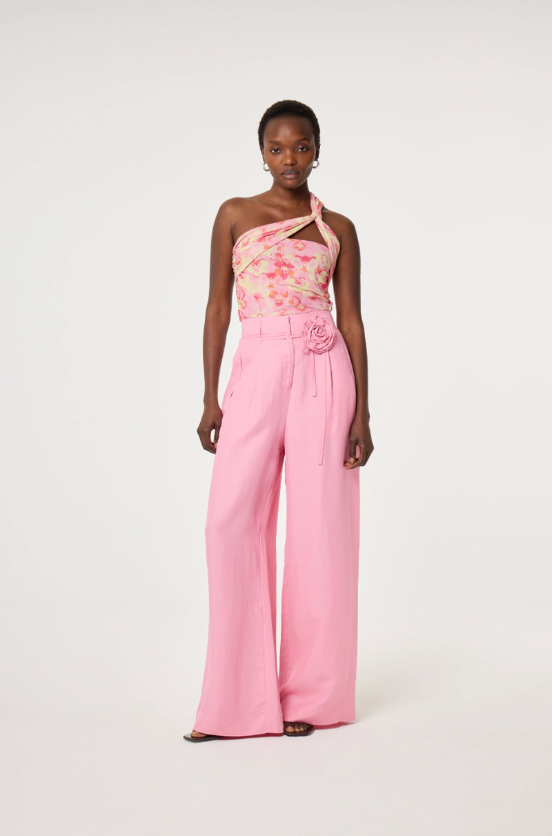 Model wearing a floral one-shoulder top and pink linen mix Fabienne Chapot wide-leg pants with corsage belt