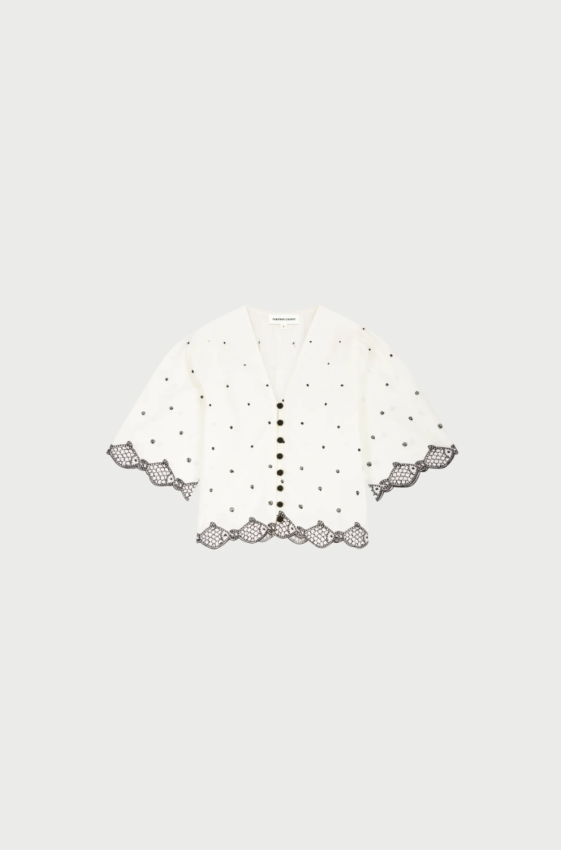 flat lay of Tylera blose showing embroidered detail and sleeve length